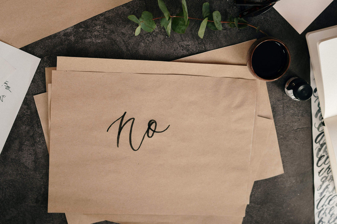 Say No - Image of the word "no" written on a plain brown sheet of paper