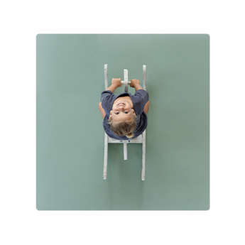 A green Toddlekind Classic Mat with a baby lying on it, viewed from above. Alt Img