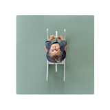 A green Toddlekind Classic Mat with a baby lying on it, viewed from above. Alt Img