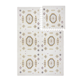 Interlocking foam tiles with lifted corner showing puzzle edges of the toddlekind baby toddler foam modern designer puzzle play mat haven amira golden clay.