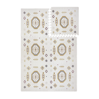 Interlocking foam tiles with lifted corner showing puzzle edges of the toddlekind baby toddler foam modern designer puzzle play mat haven amira golden clay.