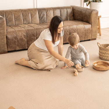 Mother and toddler playing with wooden toys on the toddlekind baby toddler foam modern designer puzzle play mat haven deco latte.