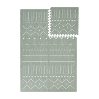 Interlocking green foam tiles with one tile removed from toddlekind baby toddler foam modern designer puzzle play mat haven berber moss.