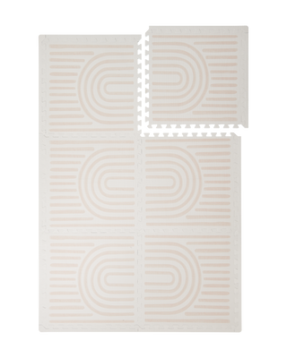 Interlocking foam tiles arranged in a grid with one corner lifted showing edges of the toddlekind baby toddler foam modern designer puzzle play mat haven linear linen.
