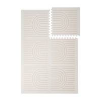 Interlocking foam tiles arranged in a grid with one corner lifted showing edges of the toddlekind baby toddler foam modern designer puzzle play mat haven linear linen.