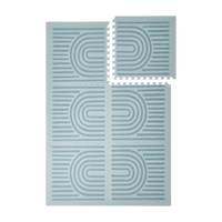 Interlocking tiles arranged in a grid with one piece lifted showing the toddlekind baby toddler foam modern designer puzzle play mat haven linear mineral.