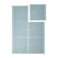 Interlocking tiles arranged in a grid with one piece lifted showing the toddlekind baby toddler foam modern designer puzzle play mat haven linear mineral.