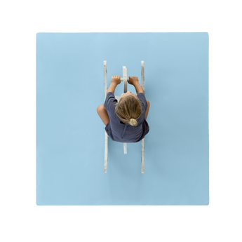 Overhead view of toddler riding toy on toddlekind baby toddler foam modern puzzle play mat classic slate in soft blue tone. Alt Img